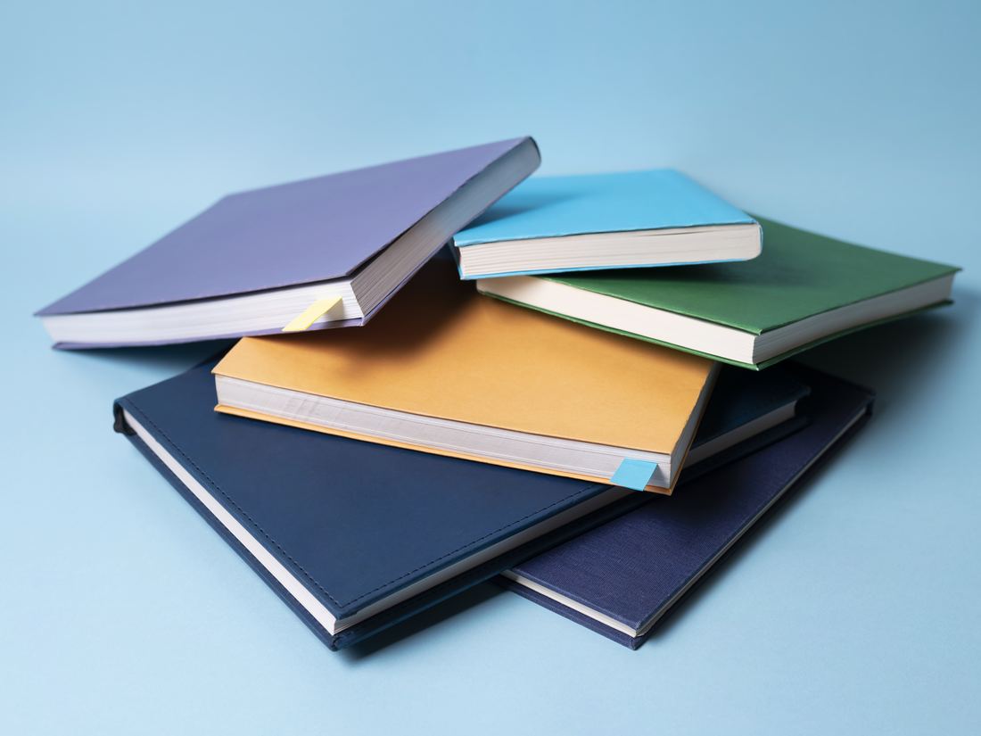Stack of custom branded corporate notebooks and diaries